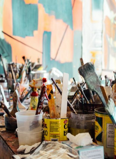 Paint brushes on a wooden table
