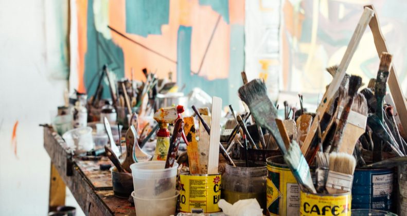 Paint brushes on a wooden table